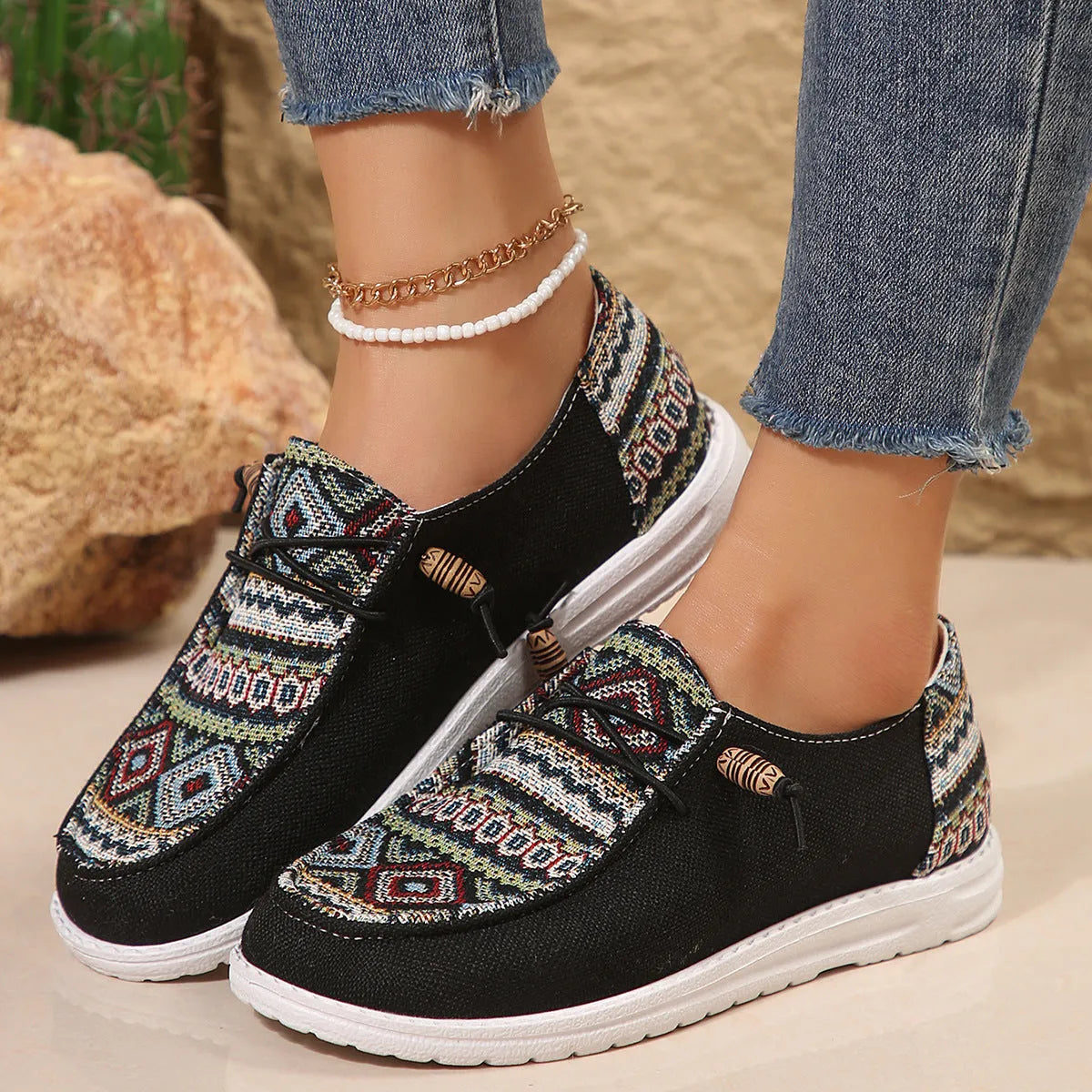 Women's black flat round toe low-top shoes with an oversleeve design on a white background.