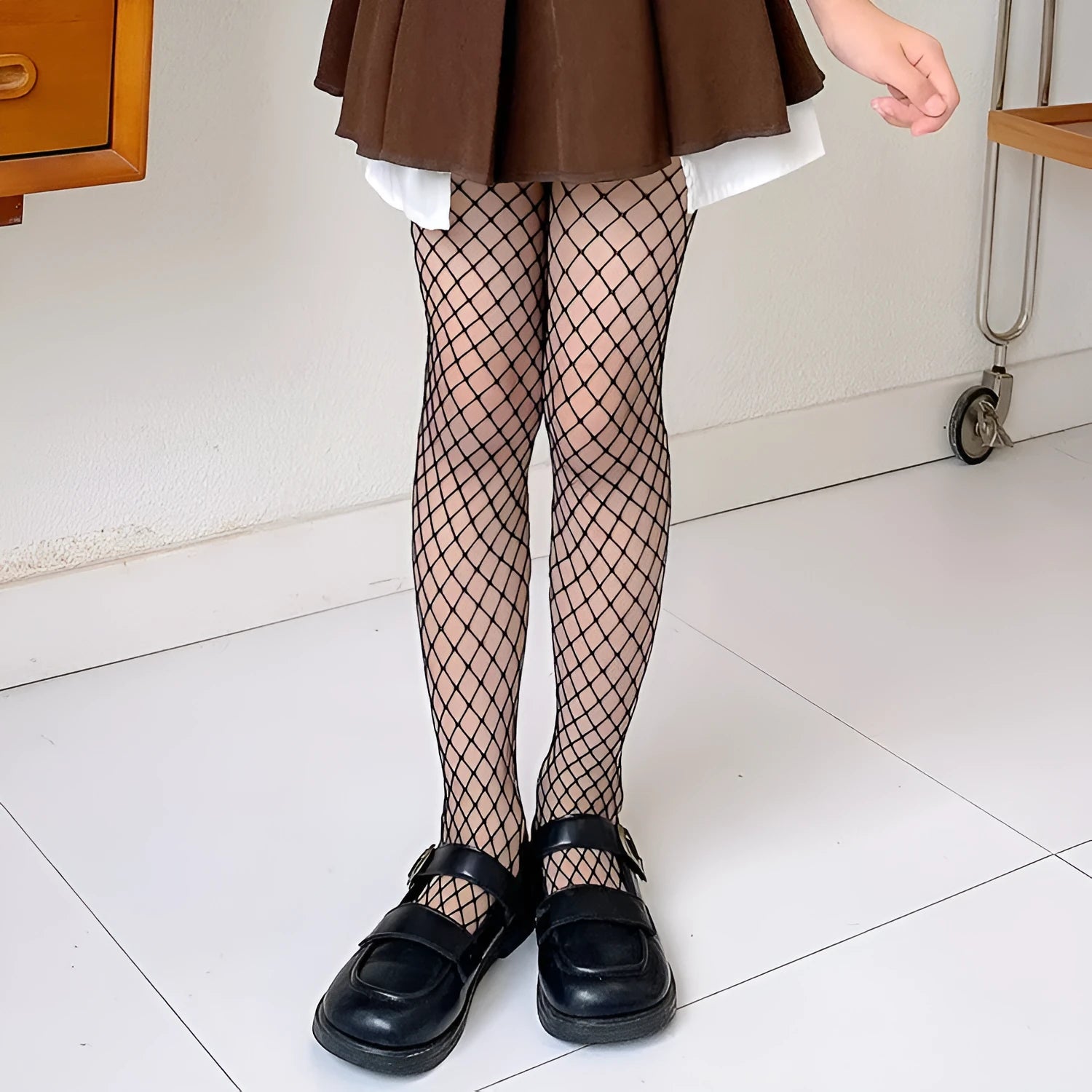 Women's mesh stockings showing large, medium and small patterns in black and white colours