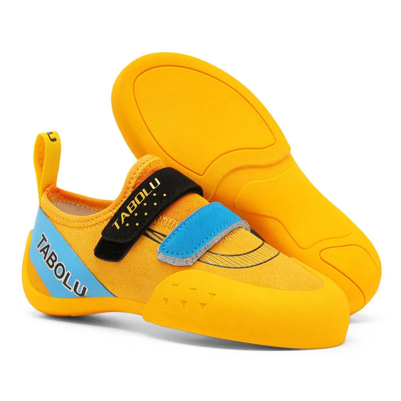 Beginner unisex rock climbing shoes with black and red colourway, showing Velcro strap and rubber sole.