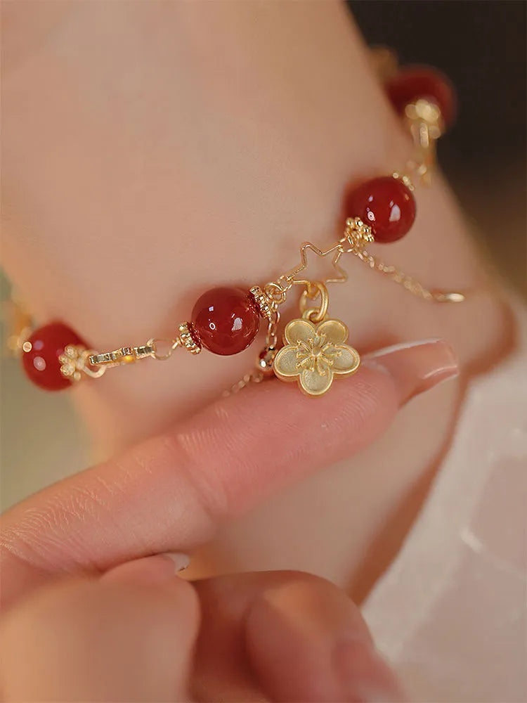 Red agate double layer bracelet for women with floral and peach blossom decorative elements.