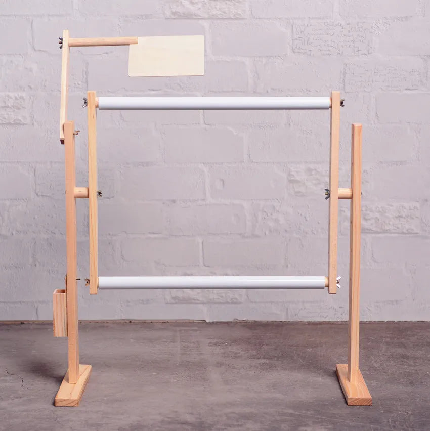 Vertical solid wood embroidery frame with height adjustment on desktop