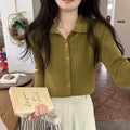 Long-sleeve viscose knit cardigan in loose fit, shown in beige colour on hanger.