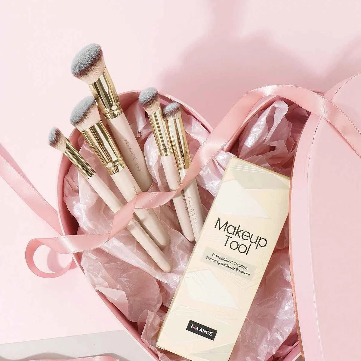 Five apricot-coloured angled makeup blush brushes with synthetic bristles arranged together