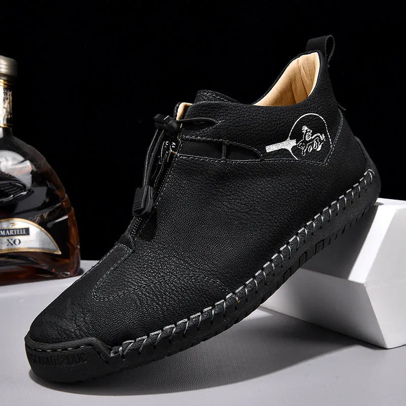 Men's black casual leather shoe with mid heel, rounded toe, and sewing thread detail on a white background.