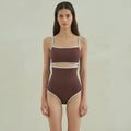 Brown women's one-piece swimsuit with triangle neckline design on mannequin
