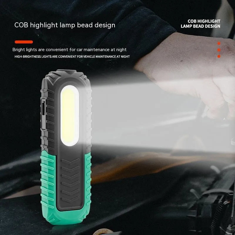 Black and green auto repair work light with USB charging port and drop-resistant coating
