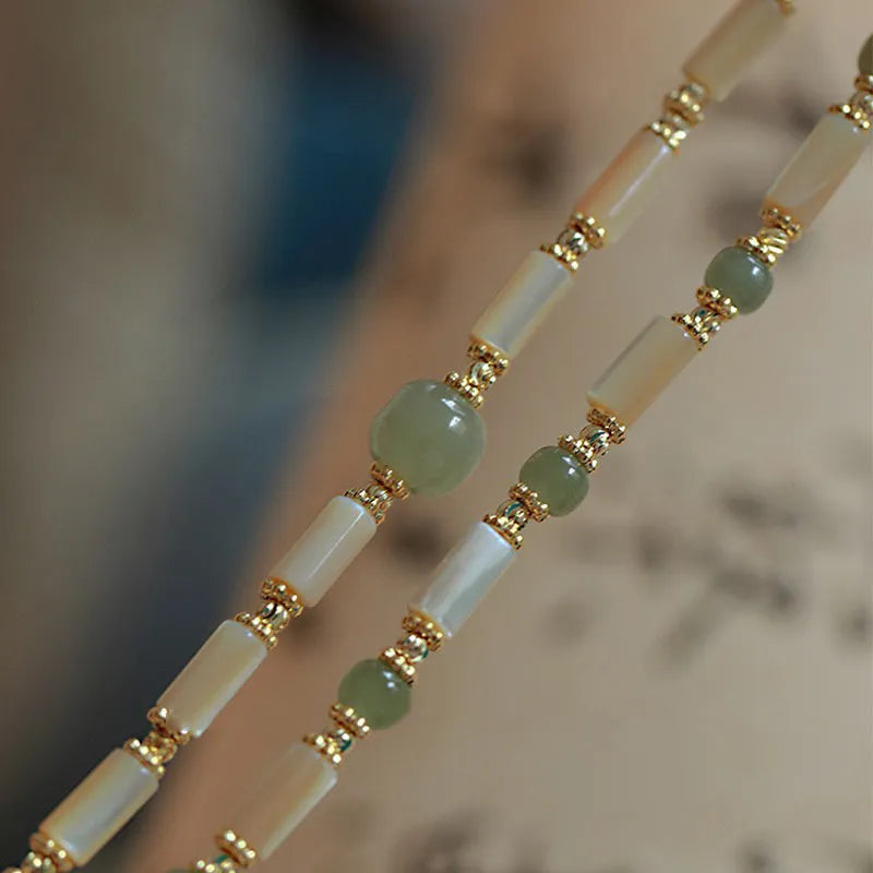 Natural white lip shell Hetian jade bracelet with round beads and geometric design