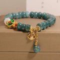 Blue jade abacus bead bracelet with alloy inlay and rhinestone decoration showing butterfly and white agate elements