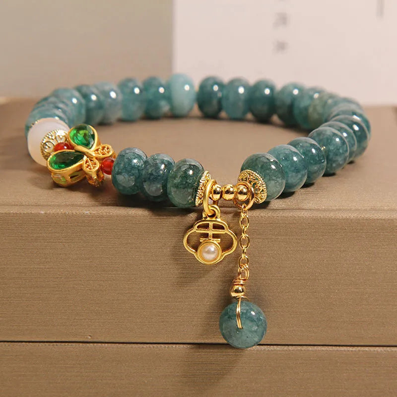 Blue jade abacus bead bracelet with alloy inlay and rhinestone decoration showing butterfly and white agate elements