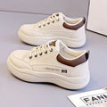 Women's white Korean-style lace-up pumps with cross straps and round toe, showing leather stitching details
