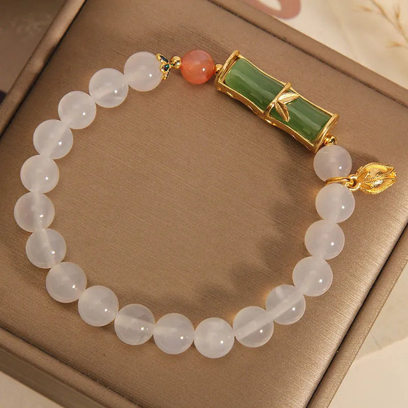 Women's Chinese style beaded bracelet with white agate centre, jade beads, and bamboo joint design.