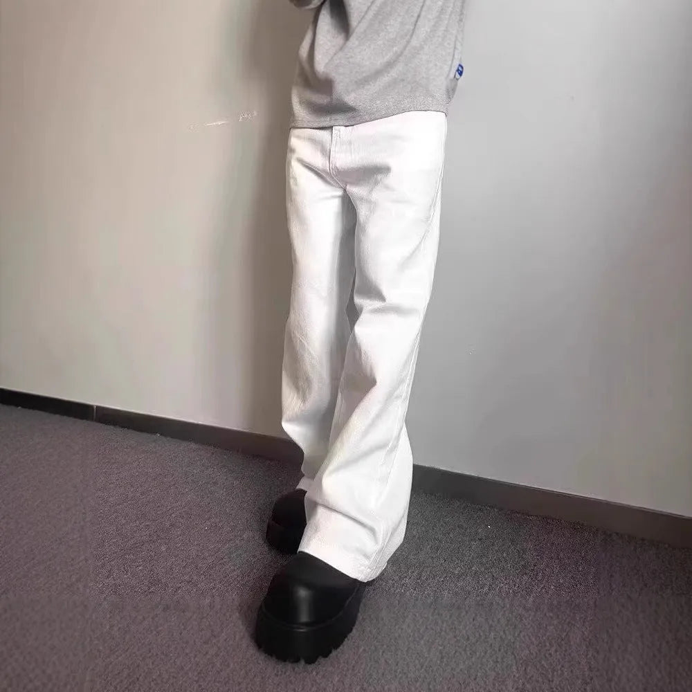 Men's white loose fit straight leg denim jeans on a mid waist with a zipper fly.