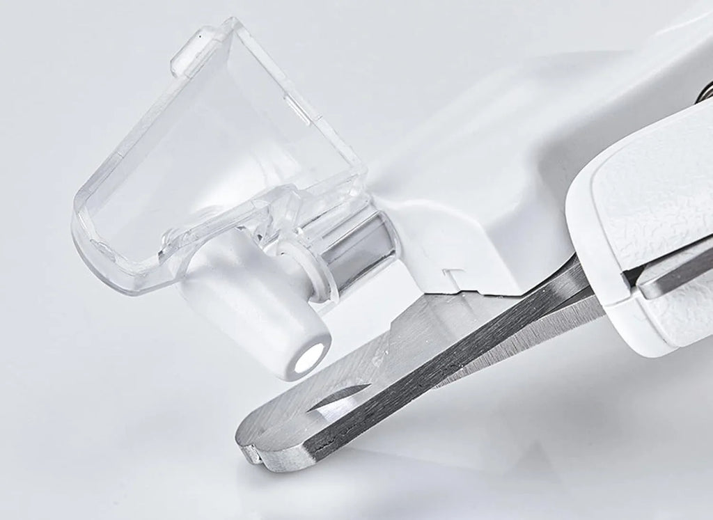 White pet nail clippers with LED light, transparent anti-splash guard, and integrated nail file on a grey background.
