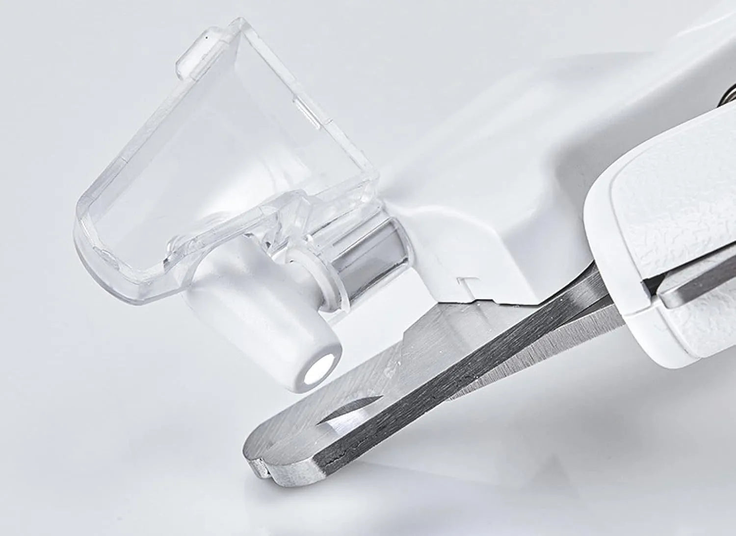 White pet nail clippers with LED light, transparent anti-splash guard, and integrated nail file on a grey background.