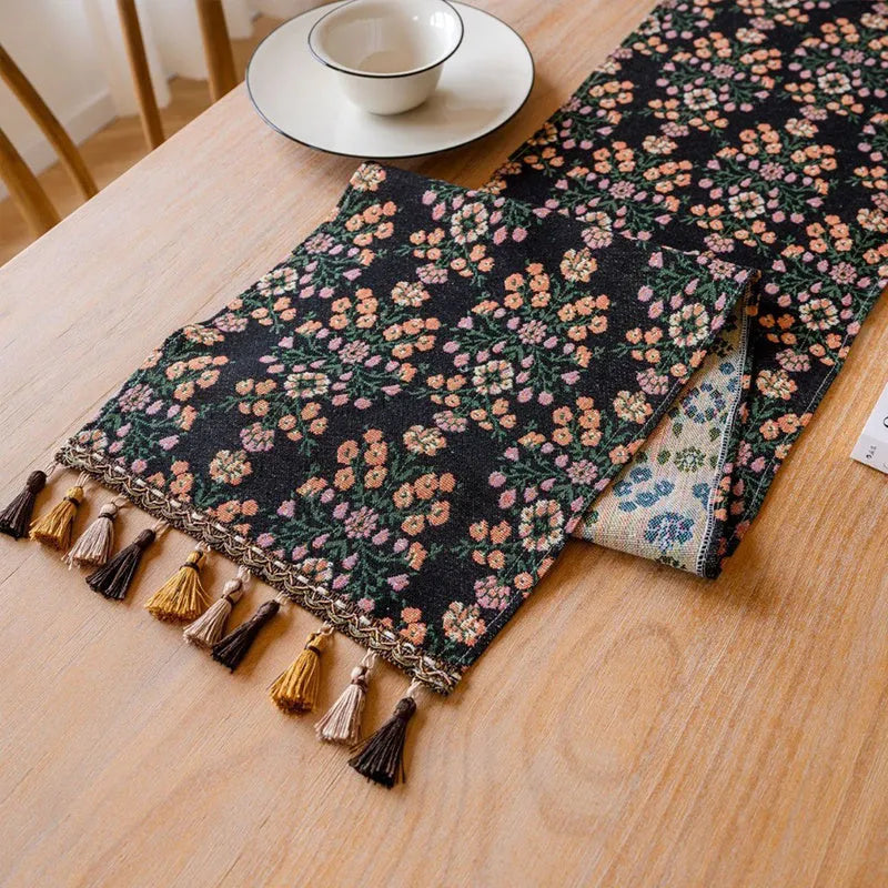 Dark blue striped table runner with fringed tassel trim laid on dining table