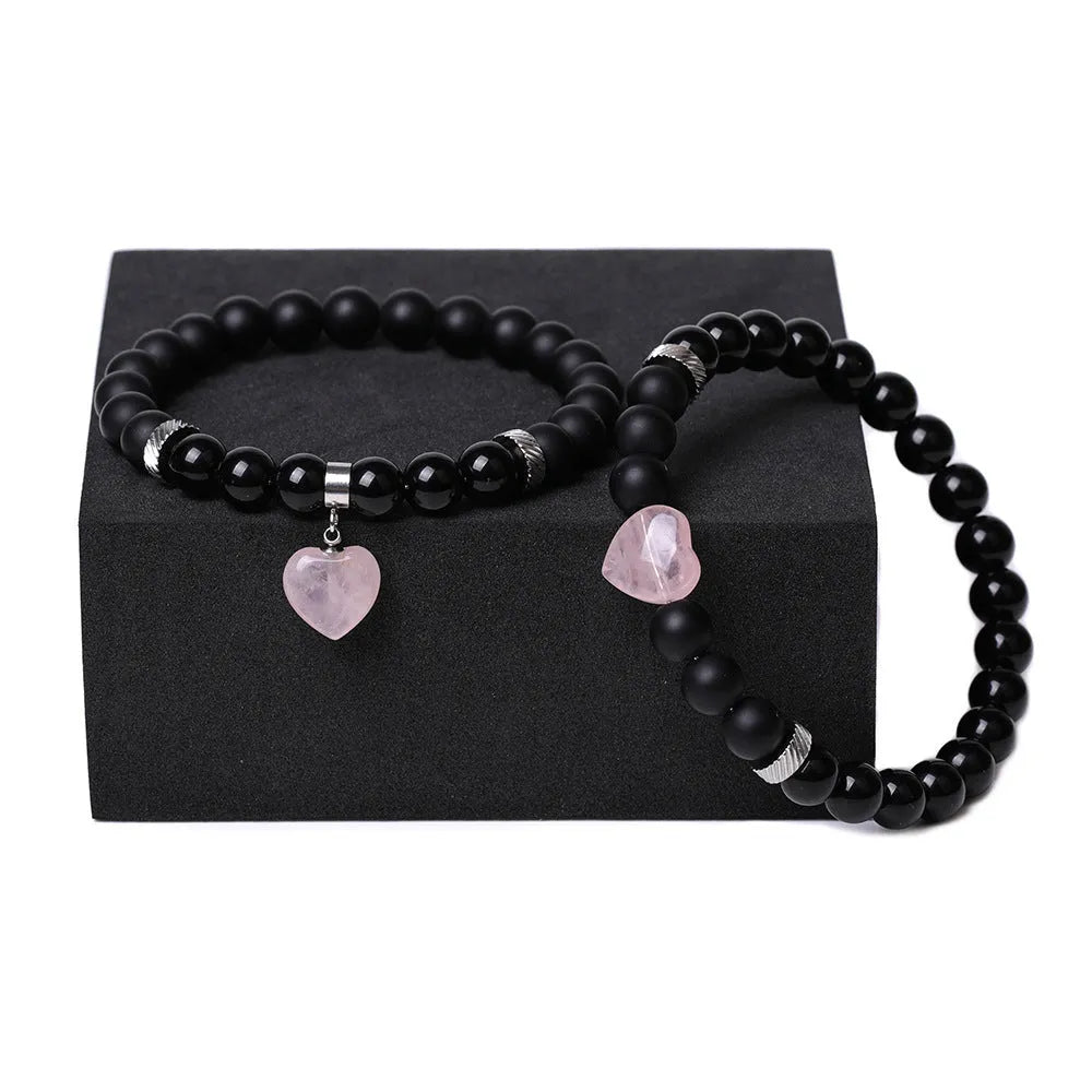 Two matching natural stone heart bracelets with geometric shape and polished finish.