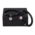 Two matching natural stone heart bracelets with geometric shape and polished finish.