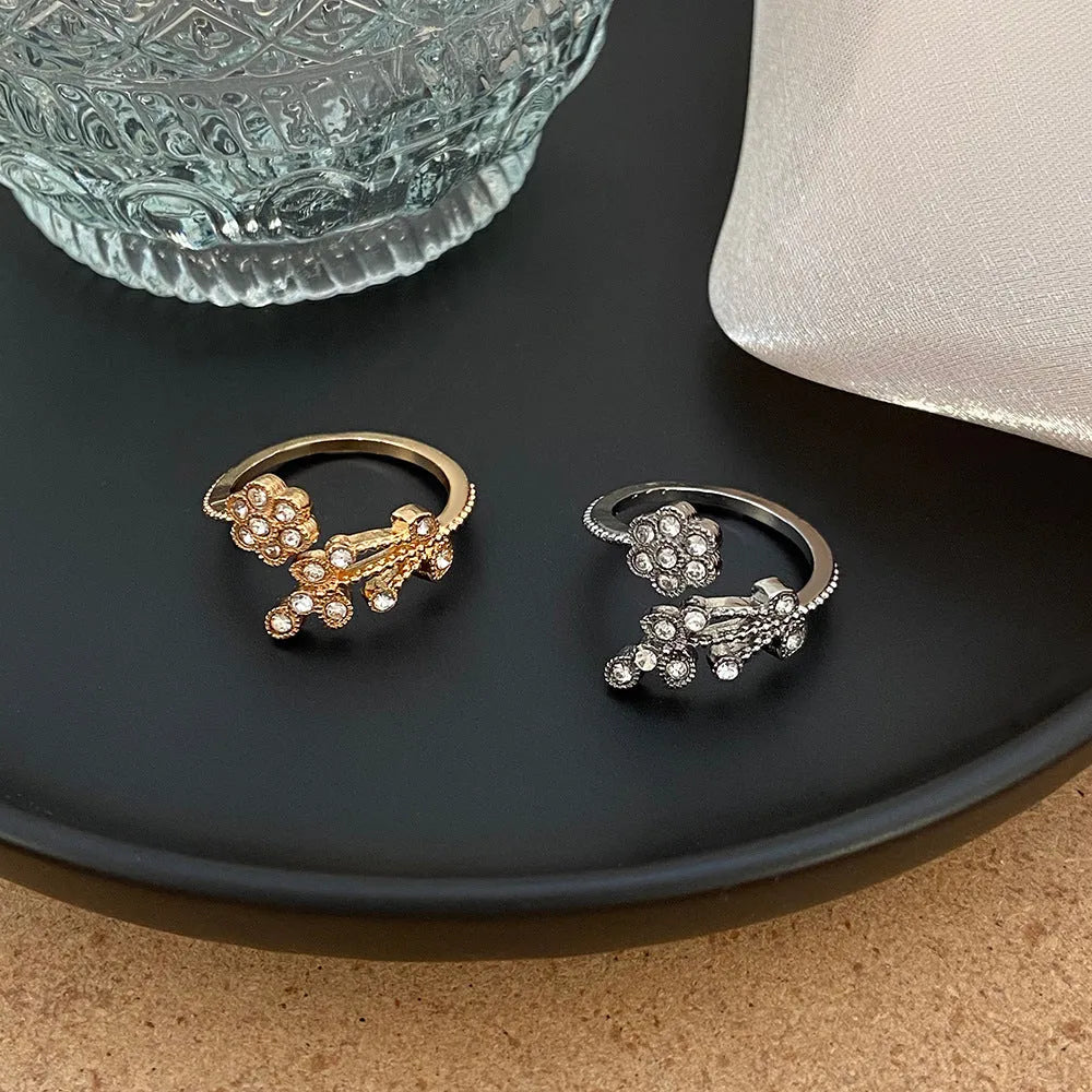 Open-mouth copper ring with diamond-cut flower and leaf design for women in gold or white finish