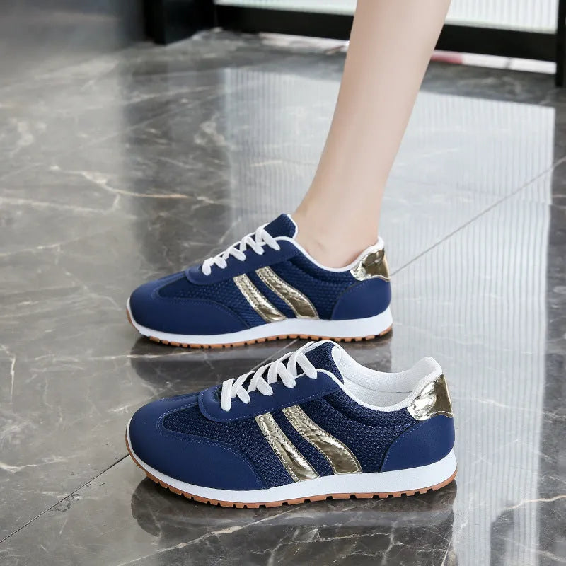 Blue women's casual tennis shoes with a cross strap and white non-slip rubber sole.