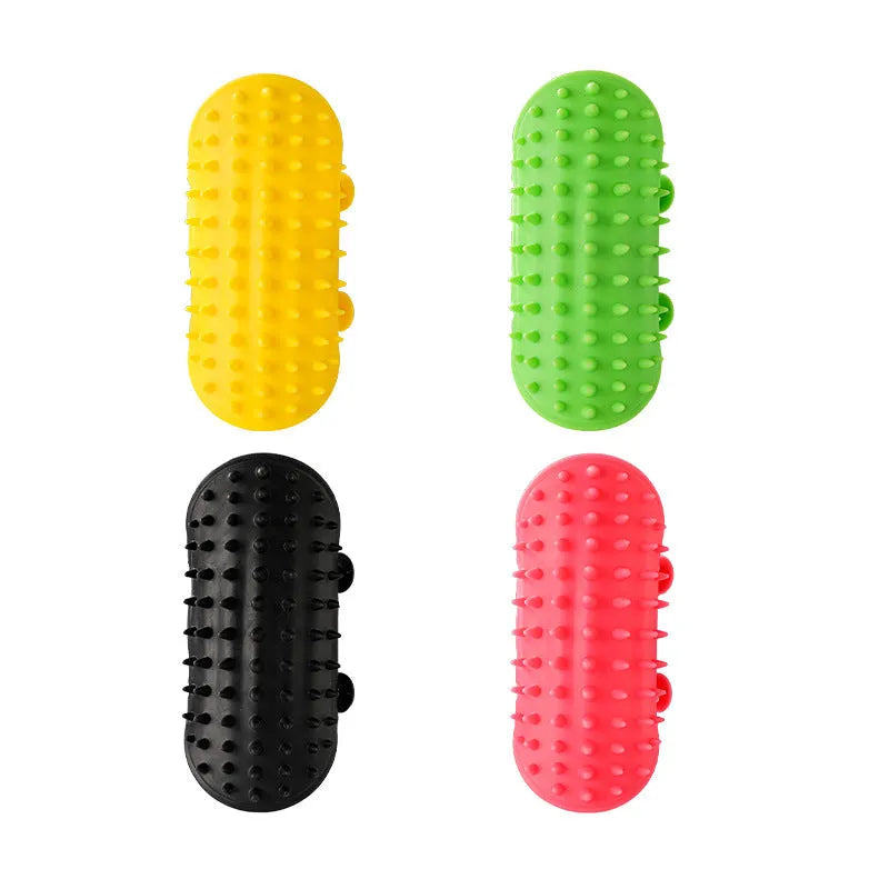 Silicone cat grooming comb with adjustable strap mounted on a table leg, shown in yellow.