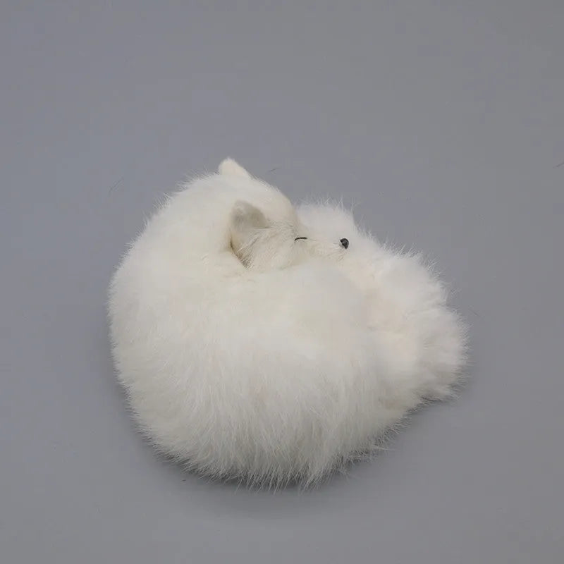 Artificial white fox fur car ornament measuring 15cm long on a car dashboard.