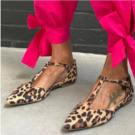 Leopard print women's pumps with pointed toe, cross strap, and a chunky low heel.