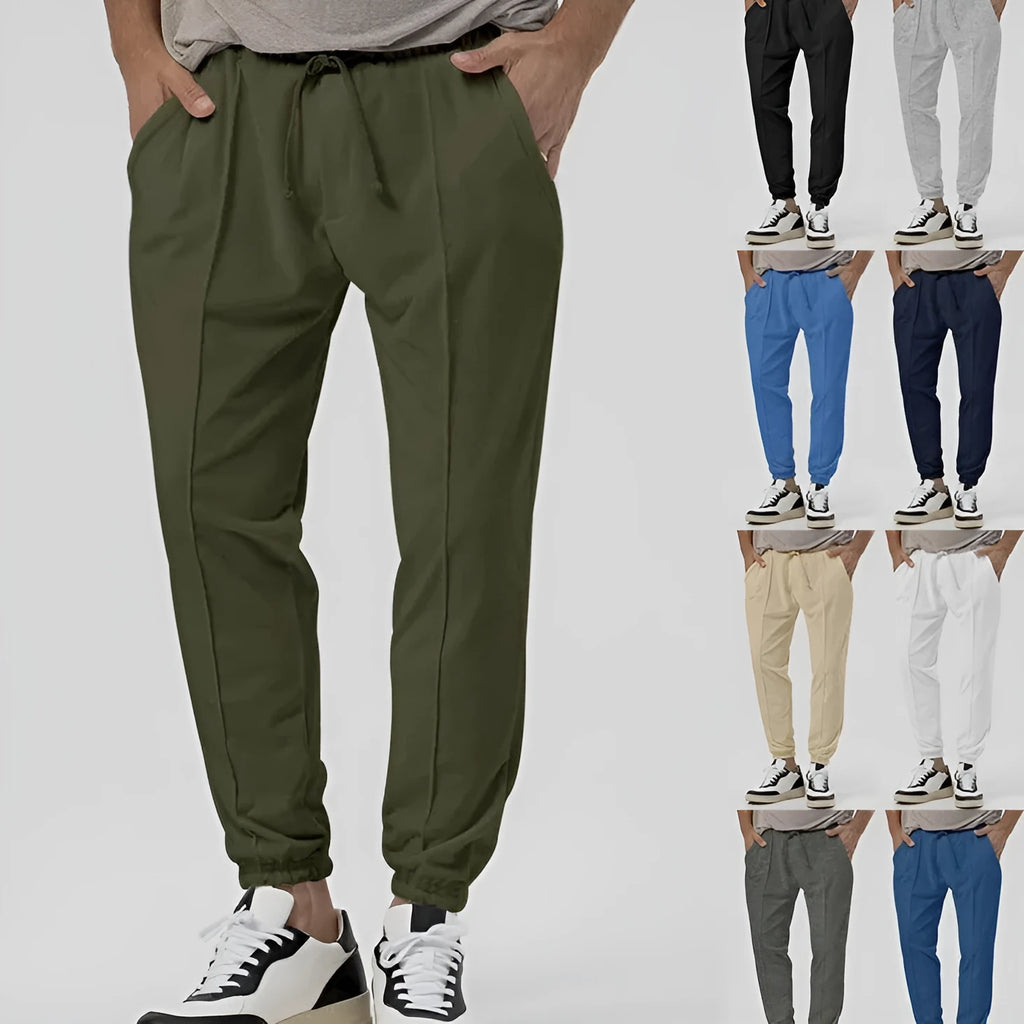 Men's grey tapered track sweatpants with straight-leg design and elastic waistband