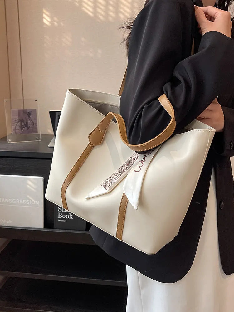 Large soft tote bag with crossbody strap shown in available colour options including black, khaki, white and pink