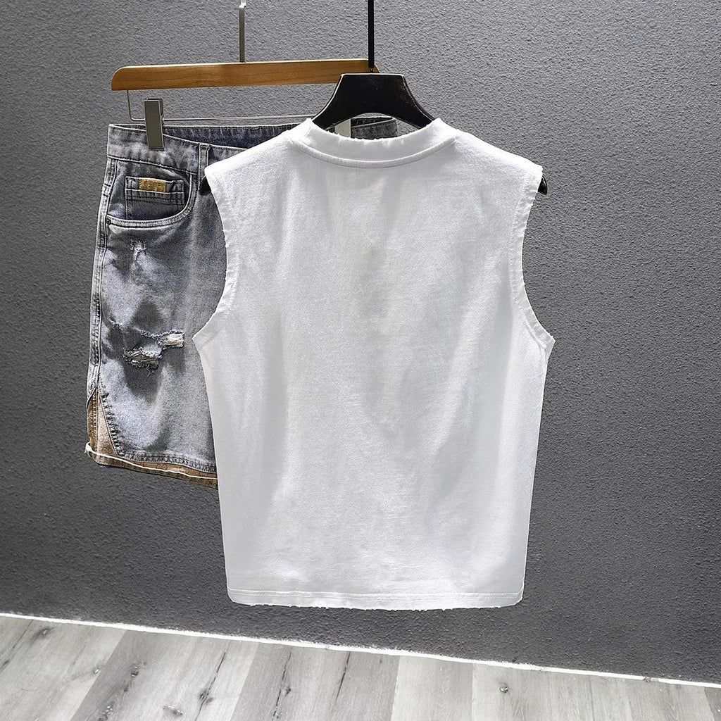 Man wearing a loose-fit black cotton sleeveless t-shirt or muscle tank.