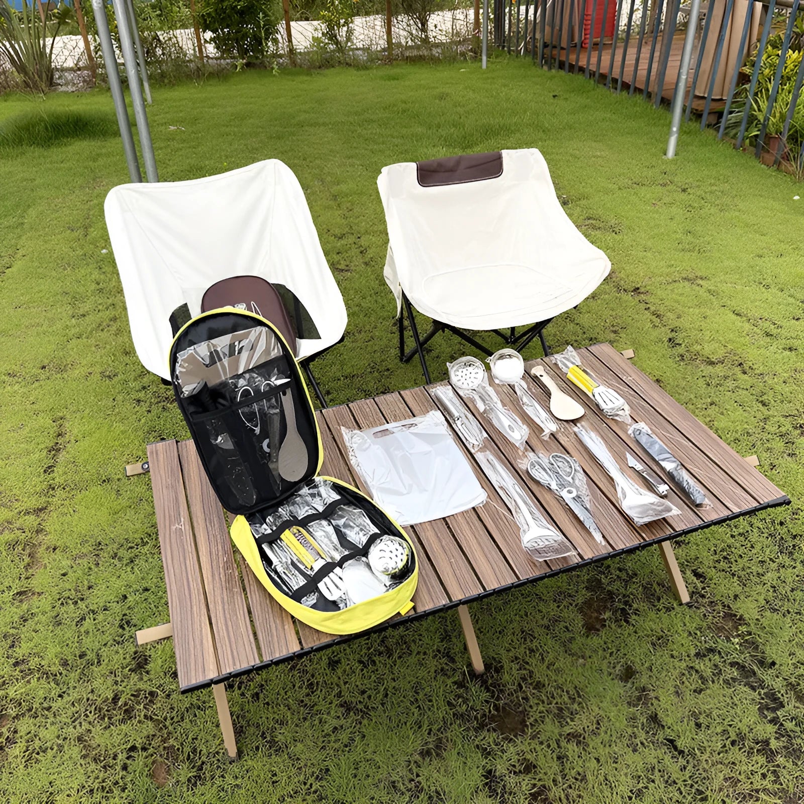 Khaki storage bag containing a 12-piece stainless steel picnic cutlery set for outdoor dining