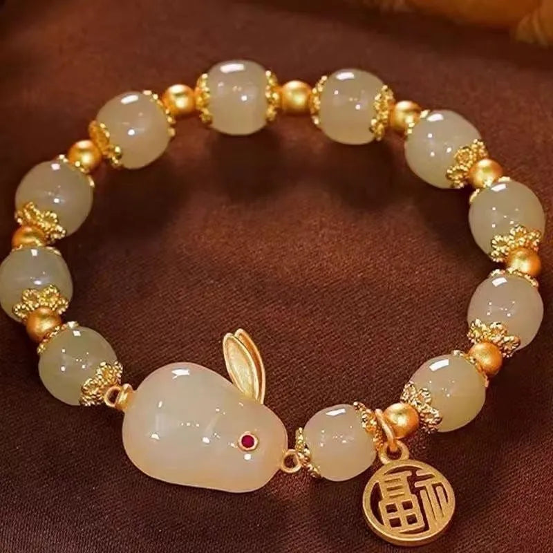 Green jade hare bracelet with black base, fu character design, and lily decorative elements
