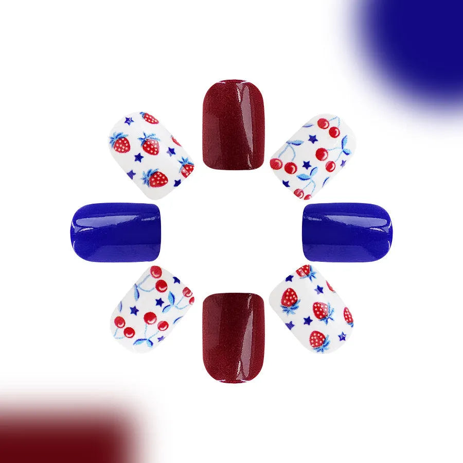 24 short glossy false nail stickers with strawberry and cherry patterns in red and blue colours