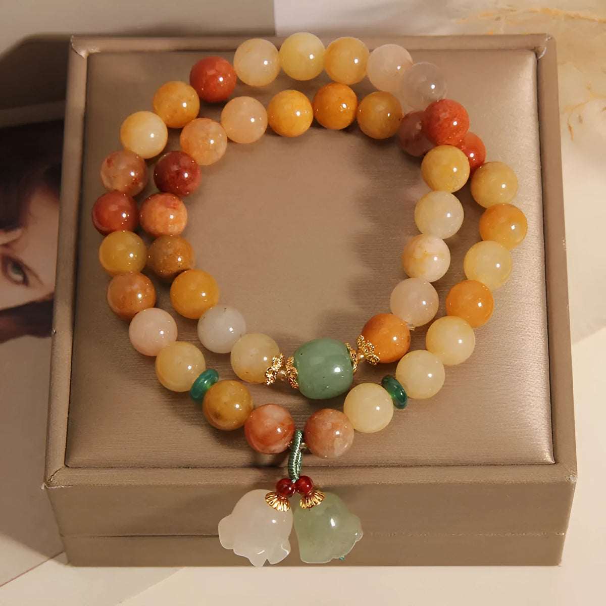 Dark green natural jinsi jade multi-layer bracelet with orchid pendant and adjustable sliding knot clasp.