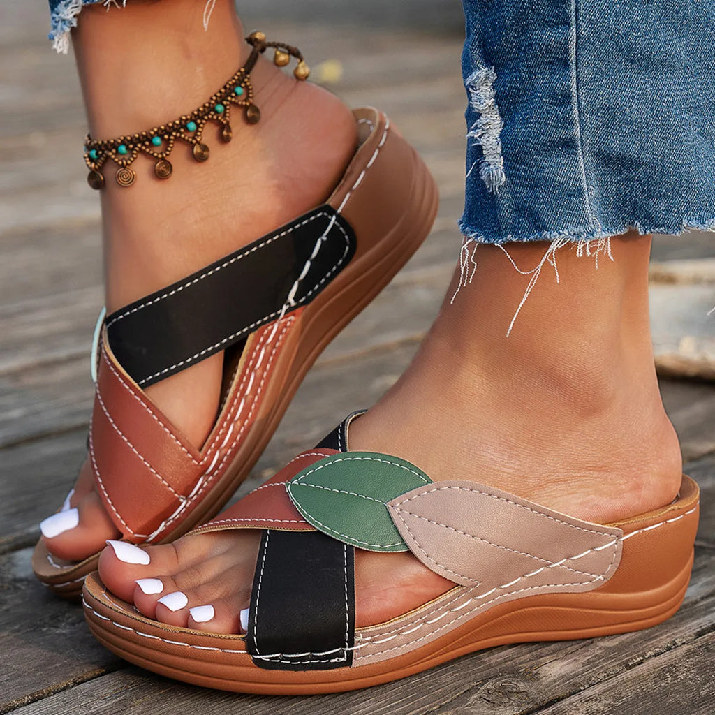Women's black thick-soled slippers with cross-strap design and peep-toe opening