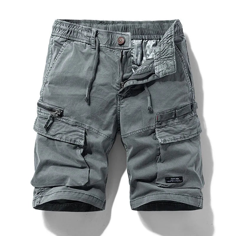 Men's army green cotton shorts with multiple pockets and a Korean-style fit on a neutral background.