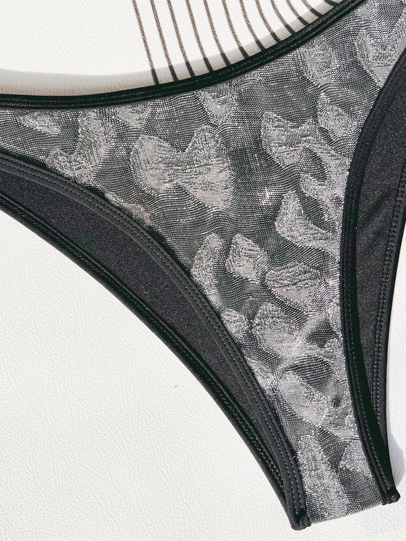 Black women's bikini swimsuit with polyester fabric and strap design