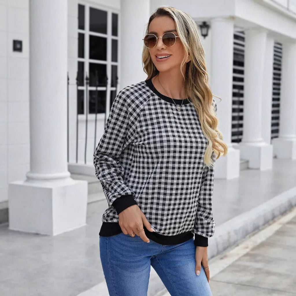 Black plaid print pullover sweater with long sleeves on mannequin