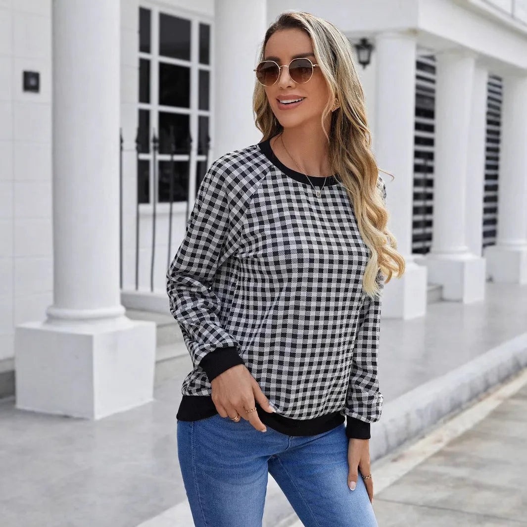 Black plaid print pullover sweater with long sleeves on mannequin