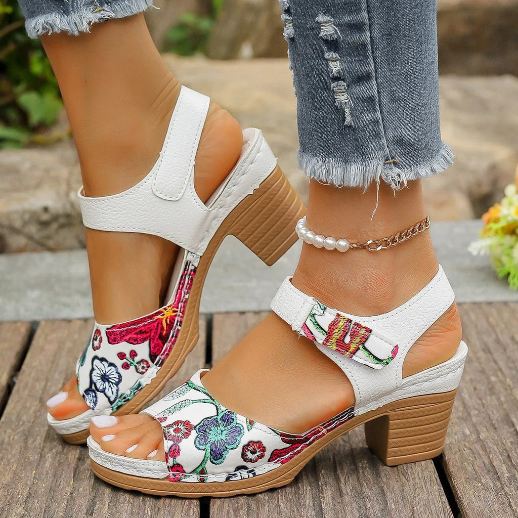 White women's high heel sandals with a velcro strap closure and rubber sole.