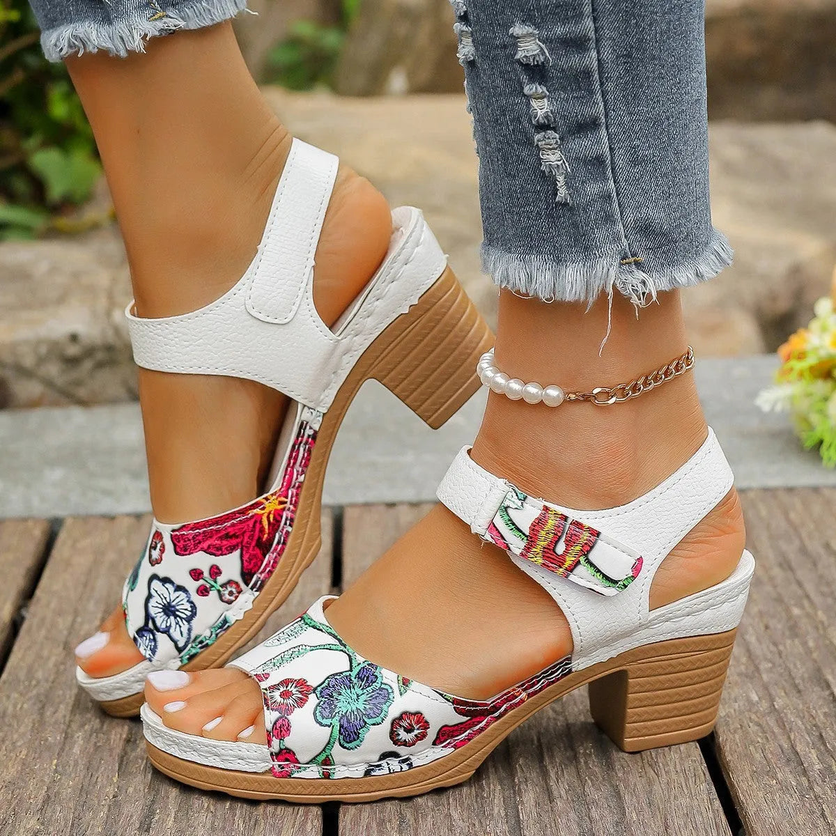 White women's high heel sandals with a velcro strap closure and rubber sole.