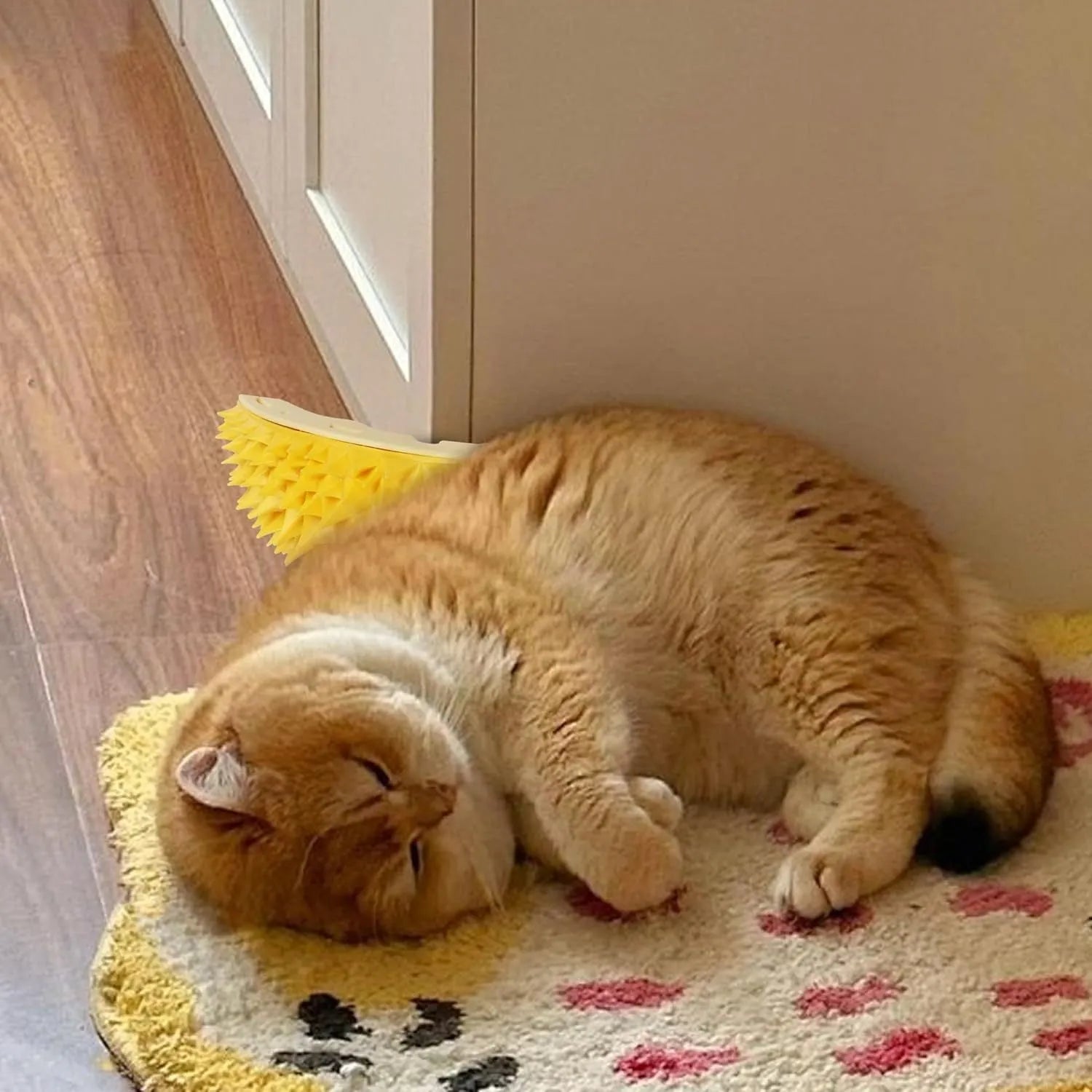 Yellow durian-shaped cat corner scratcher and groomer mounted on a wall