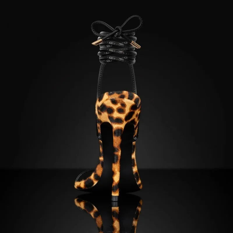 Leopard print women's gladiator sandals with pointed toe and lace-up front on a rubber sole.