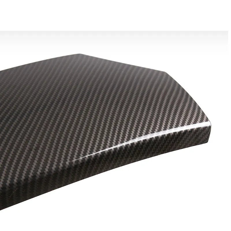 Three black ABS car armrest box covers with a glossy carbon fibre weave pattern.