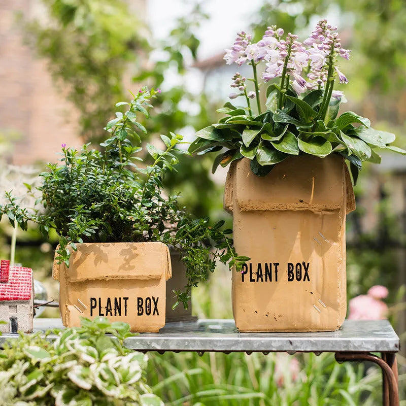 Cement brown paper box style floor planter with a drainage hole, shown in a Nordic indoor setting.