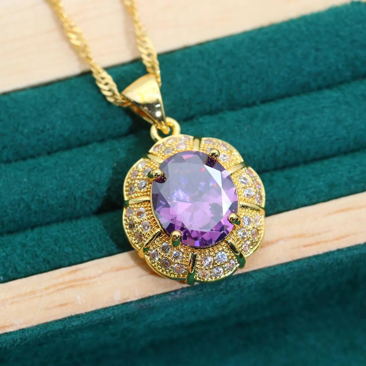 18k gold plated jewellery set with blue cubic zirconia stones showing necklace, earrings, ring, and bracelet