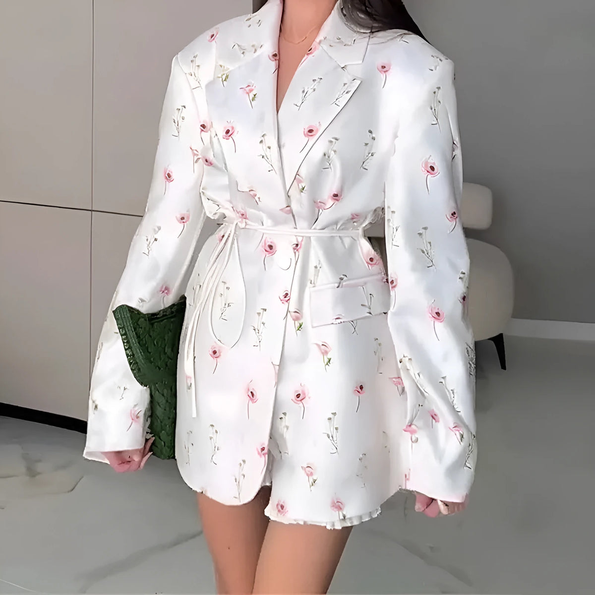 Women's suit jacket with lace-up detail at the collar and waist, shown in a floral print colour option.