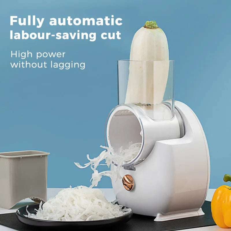 White and green electric vegetable slicer with suction base, feeding port, and multiple blades for cutting potatoes and carrots.