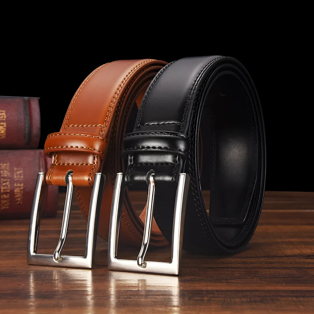 Men's black genuine leather belt with a silver alloy pin buckle fastener on a plain background