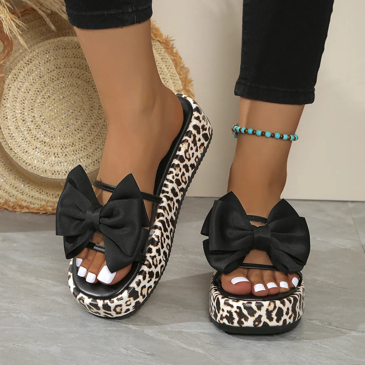 Women's black and white leopard print beach slippers with a thick sole and round toe design.