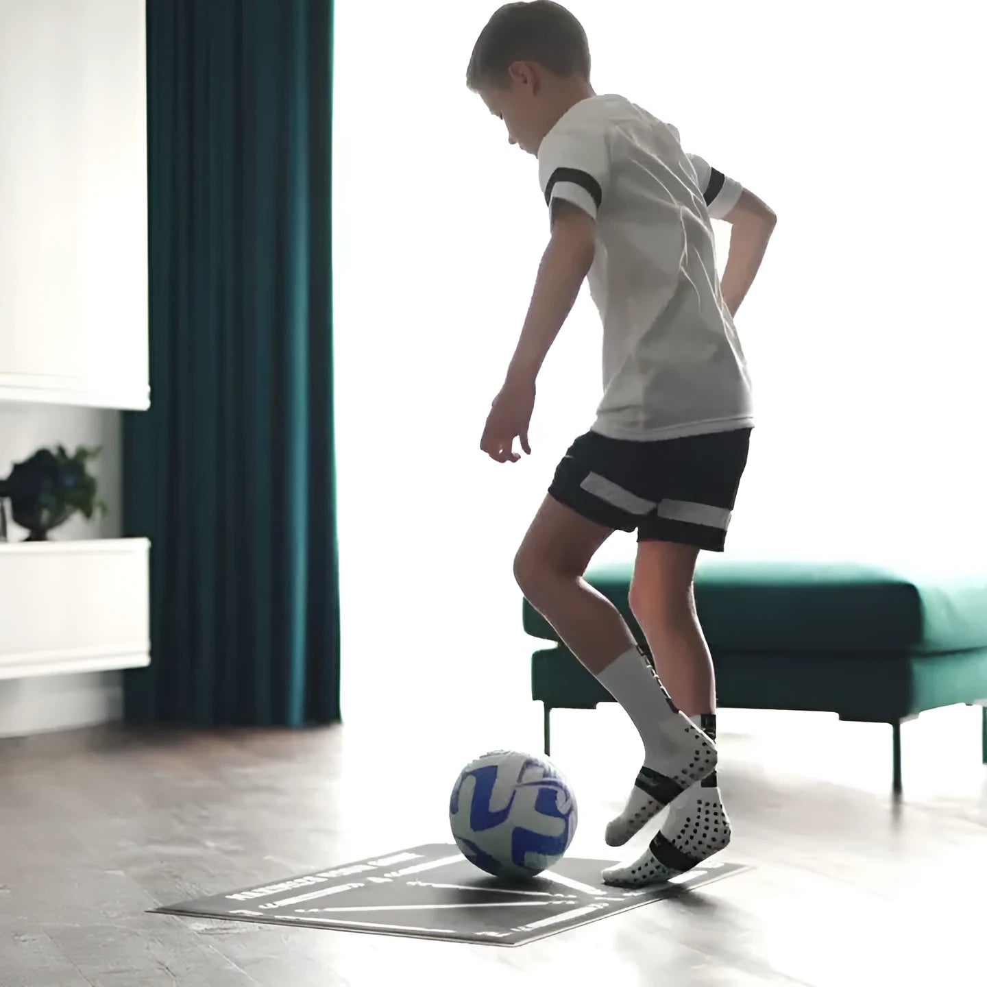 Black football training mat measuring 60 by 90 centimetres for non-slip practice